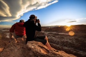 Two travellers admiring the view of Atacama desert in Chile all year