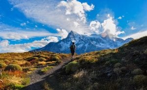 A hiker amongst the mountains in chile. Clear blue skies and snow capped mountains