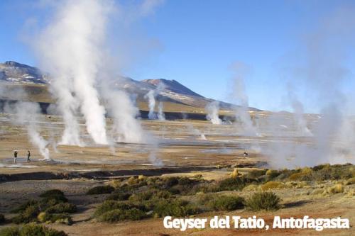 Geyser del Tatio Antofagasta, Chile. Smoke coming from the ground. People walking between the smoke towers.