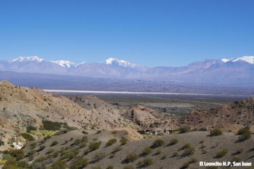 A lookout in Leoncito National Park San Juan, Argentina. Desert brown  and dry landscape in the front, ice capped mountains in the back.